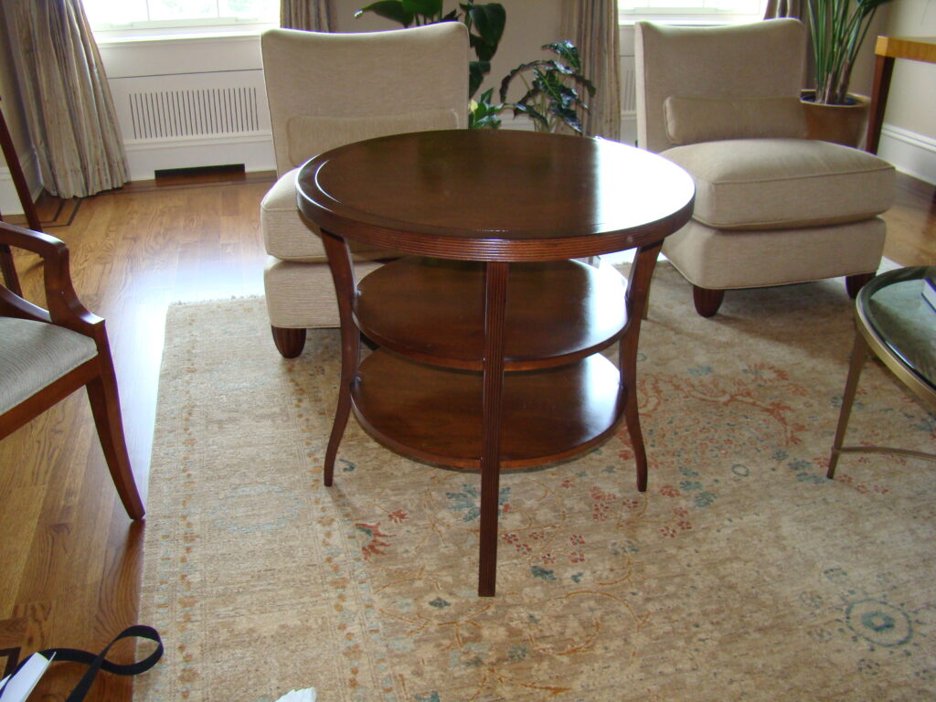 Barbara Barry side entry table — restored and styled in client’s home with surrounding upholstered furniture and patterned rug