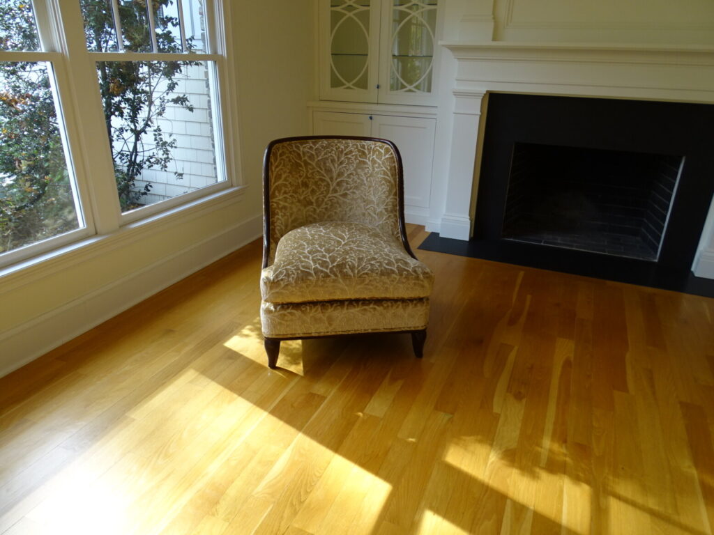 Elegant upholstered chair fully restored and reupholstered, shown after completion in a finished interior.