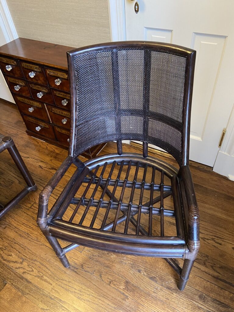 Bamboo lounge chair with a woven backrest and slatted seat.