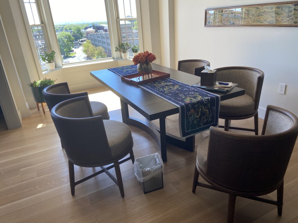 Dining area with the full table and chairs arranged after all on‑site chair repairs were completed.