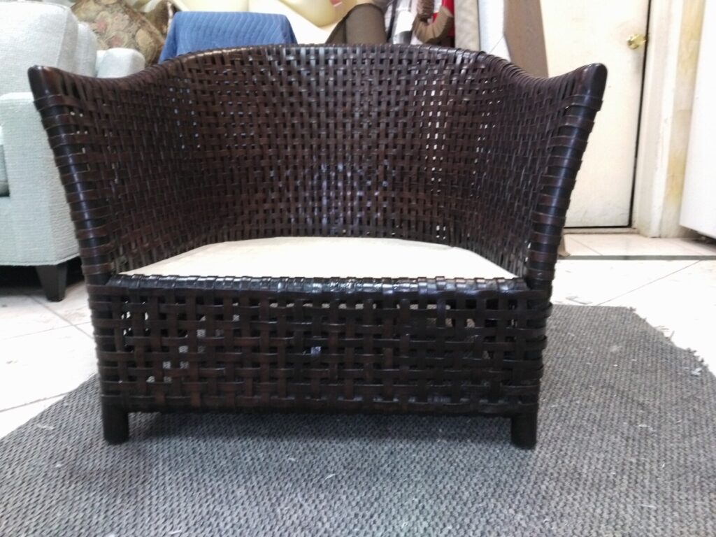 McGuire outdoor lounge chair after restoration showing refreshed woven‑resin rawhide detail.