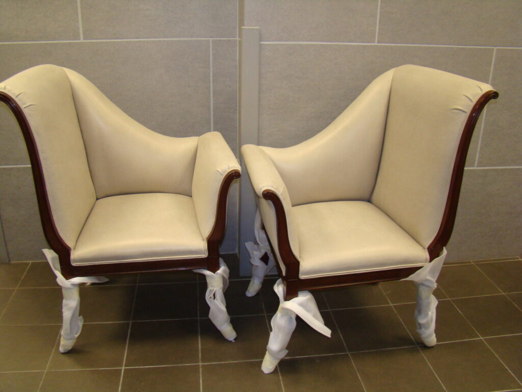 Luxury restoration of a Baker Parler chair showcasing artisan frame refinishing and precision upholstery for iconic high-end designer collections.