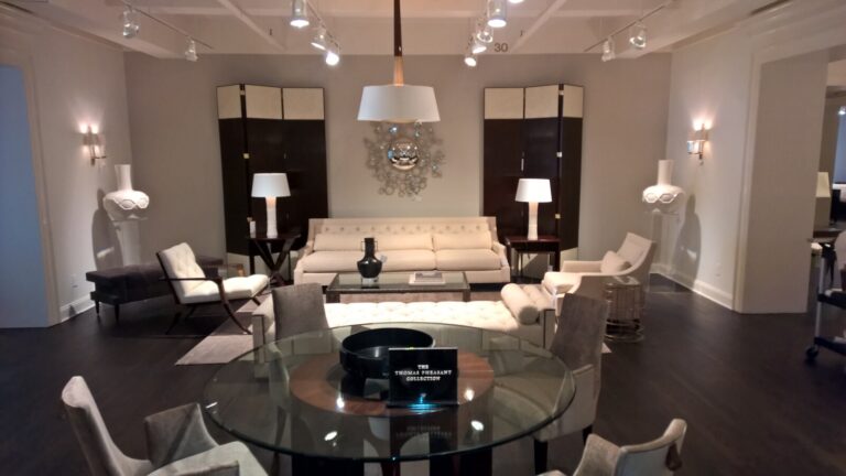 “baker showroom display featuring a tufted bed, accent chair, and nightstand from the thomas pheasant collection, restored and serviced by first class mastercraft.