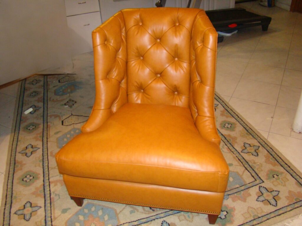 Luxury Baker furniture restoration showcasing master-level leather upholstery and tufted chair refinishing for a high-end residential interior.
