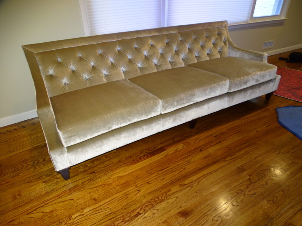 Restored Baker Thomas Pheasant Max sofa featuring a sophisticated diamond-tufted back, sleek bench-style seat cushion, and elegant tapered wood legs in a velvet finish.