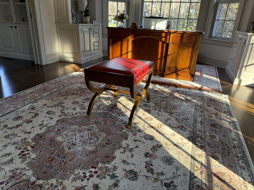 Baker antique red leather bench ottoman fully upholstered and delivered to the client’s home.