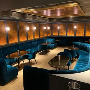 Custom channel‑tufted curved restaurant booth installed in a commercial dining space.