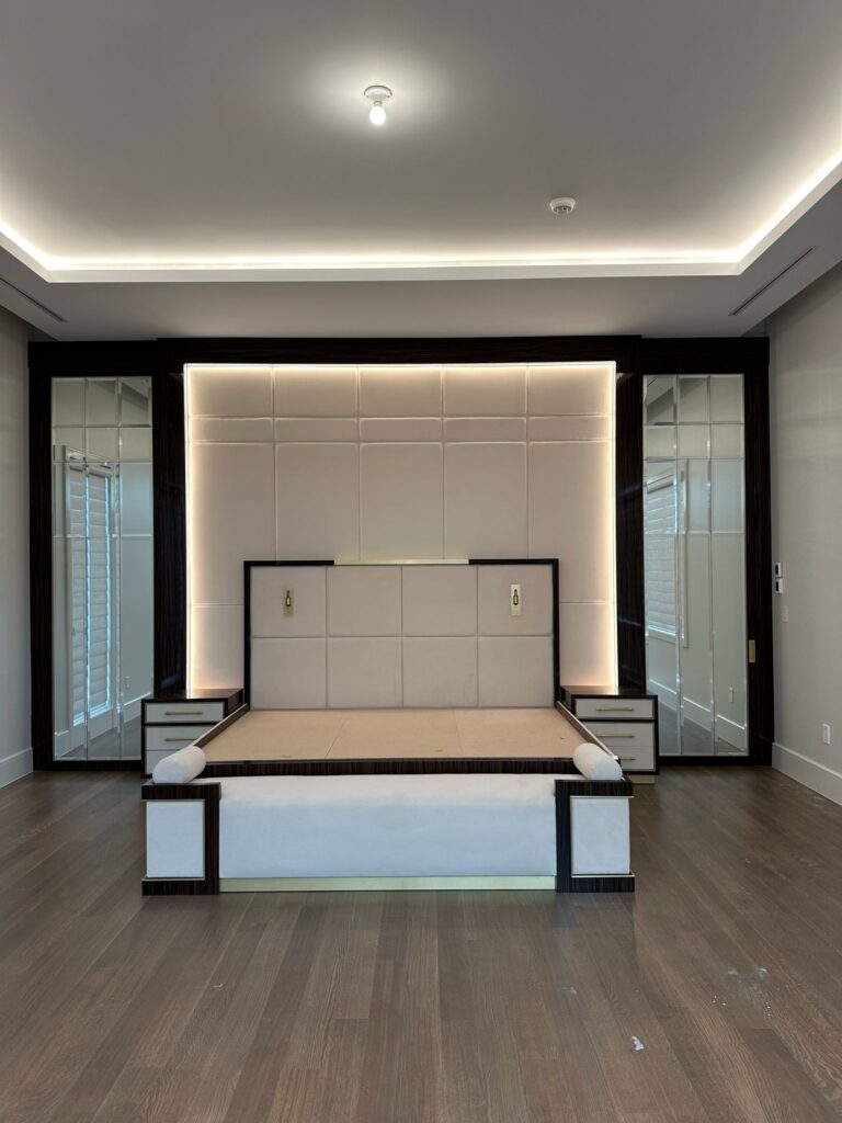 Finished backlit fabric headboard with integrated floor-to-ceiling mirrors and matching bed frame.