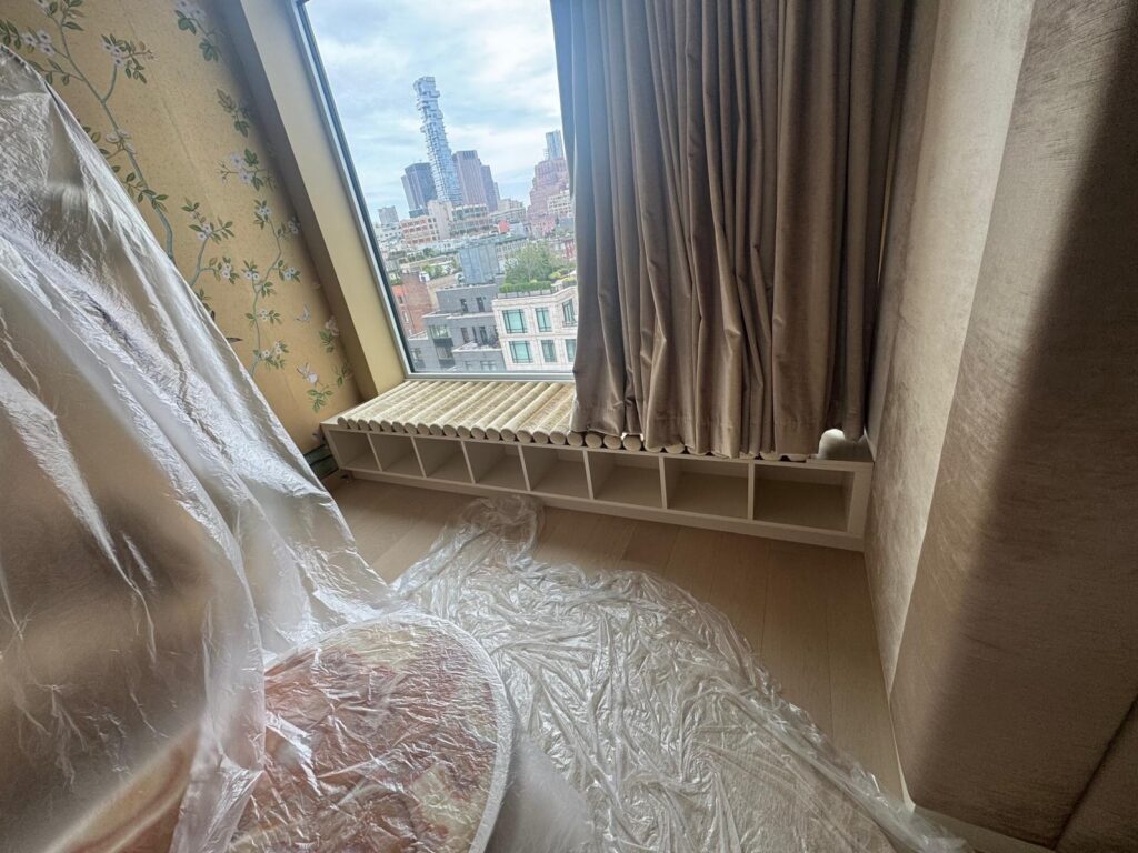 Custom banquette in the client’s home with completed seat and roll cushions being fitted.