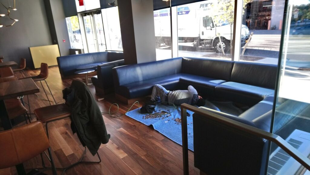U-shaped banquette positioned in a corner during on-site installation.