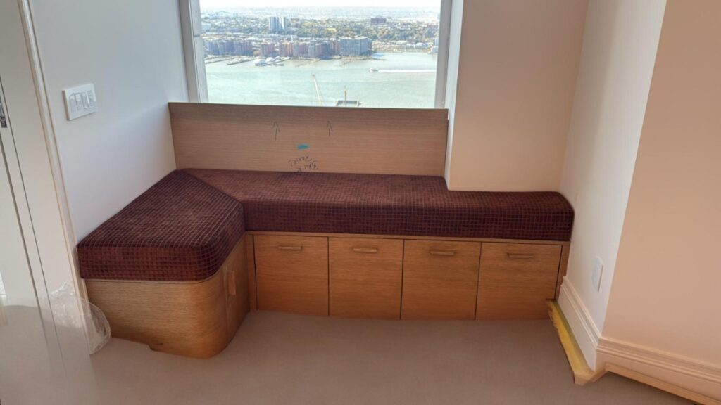 Custom window banquette with built‑in storage drawers and upholstered seat.