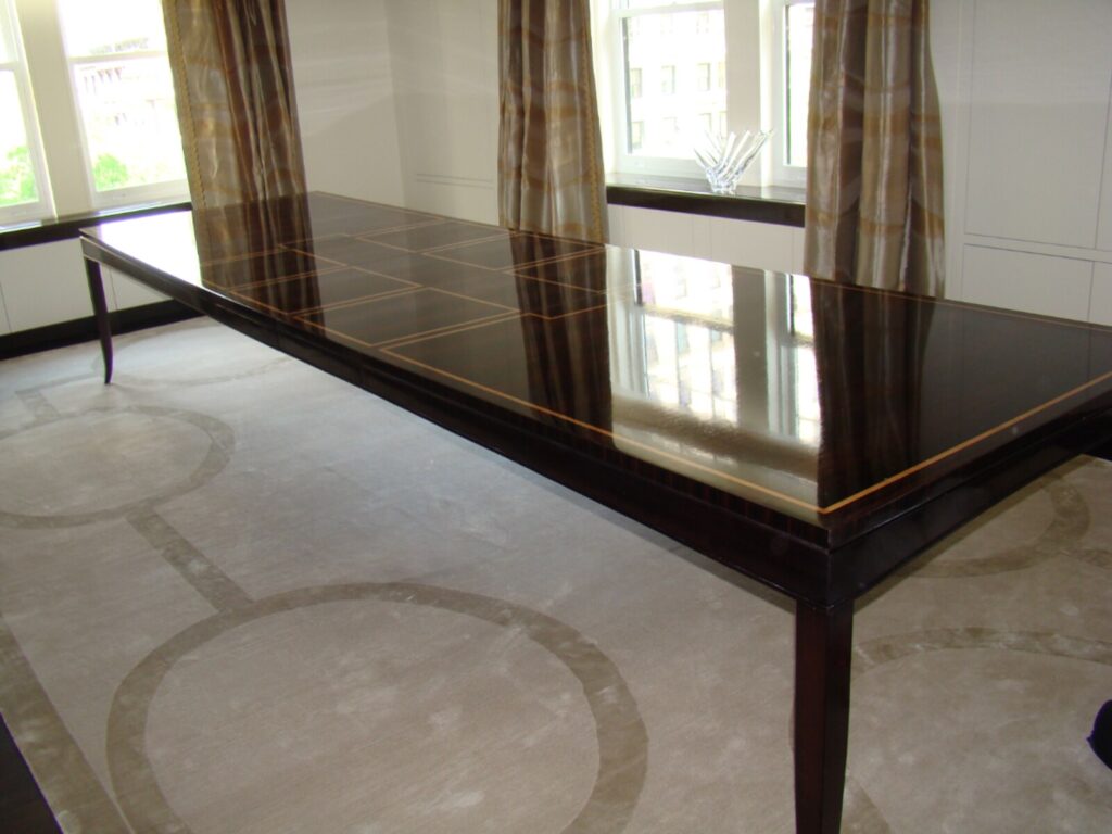 Baker custom inlay dining table restored with a high‑gloss piano finish in NYC.