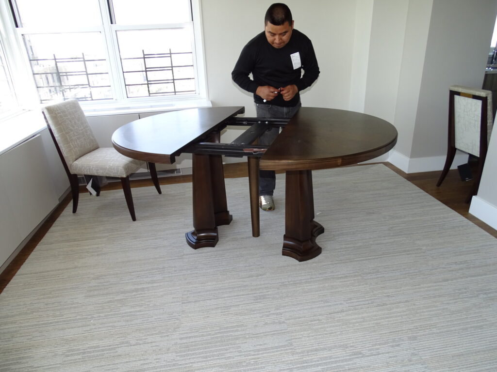 Baker dining table being assembled during on‑site service in NYC.