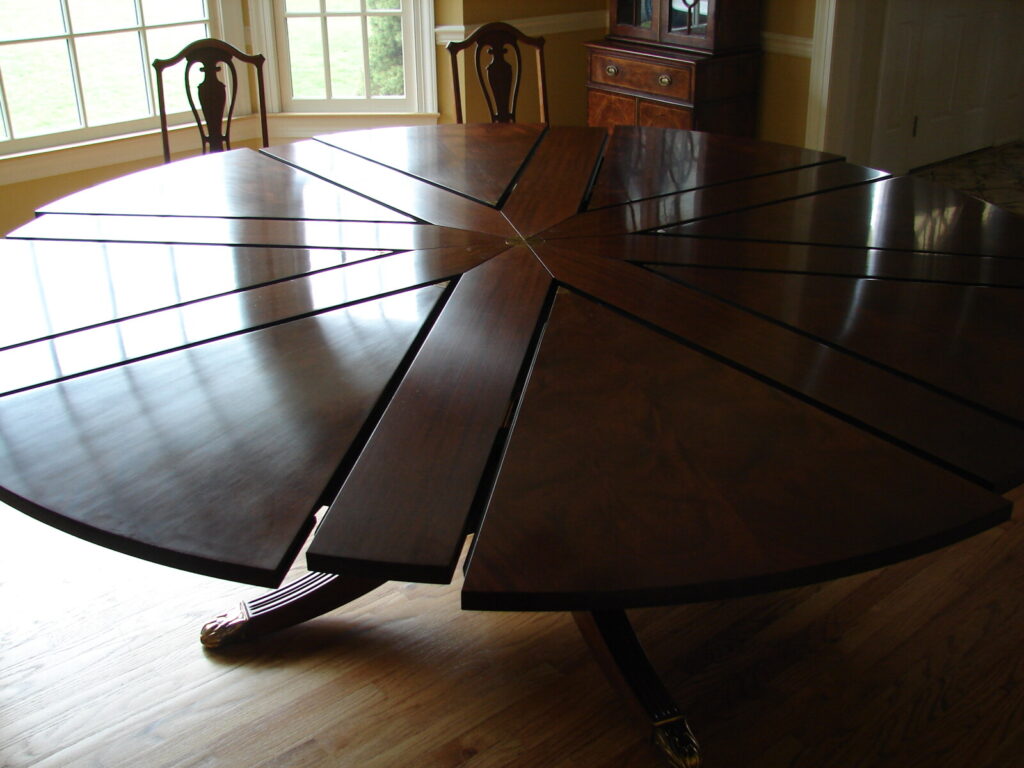 Baker Jupe table in figured walnut with sunburst top refinished and restored.