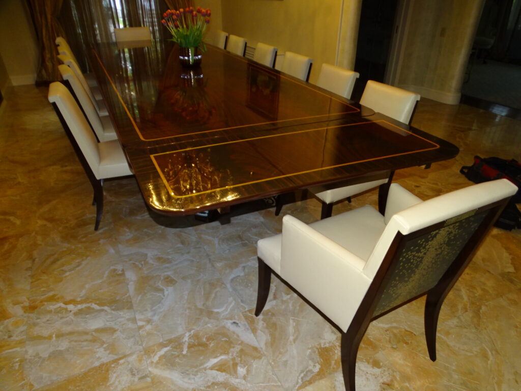 Baker satinwood‑banded dining table restored with a high‑gloss finish.