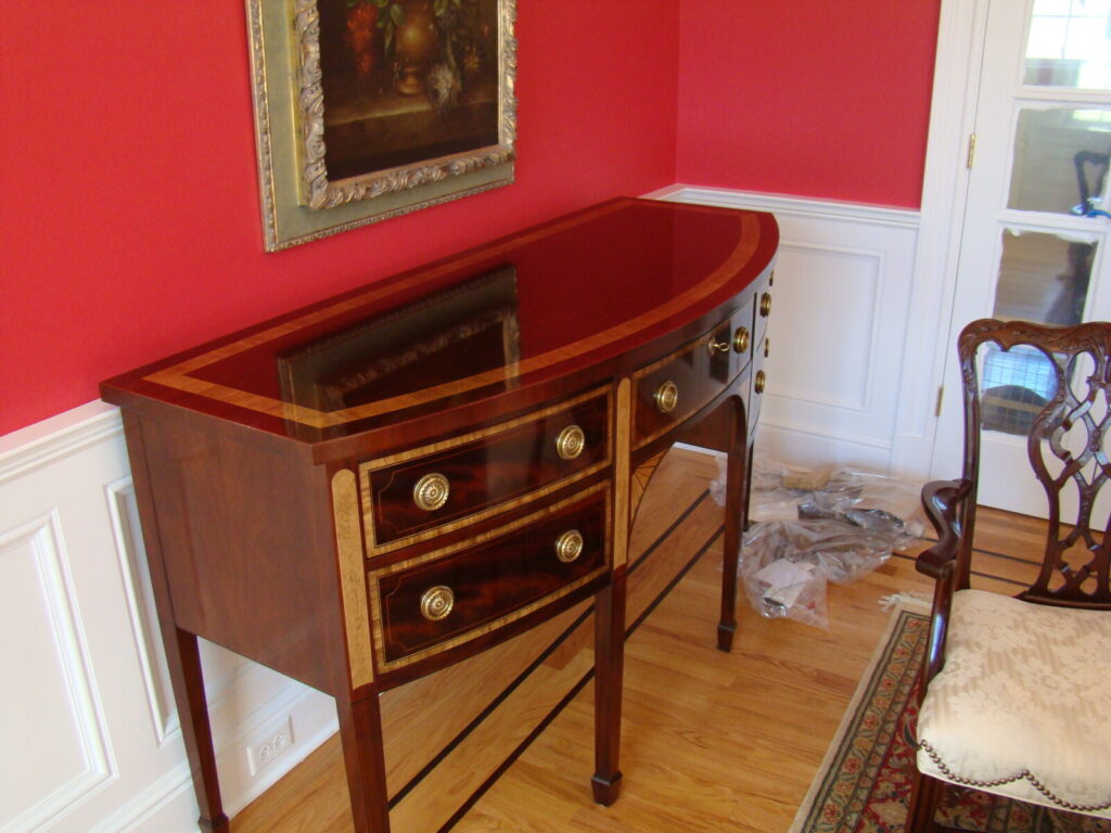 Mahogany sideboard with restored inlay and refinished surfaces, shown after delivery in a finished interior.