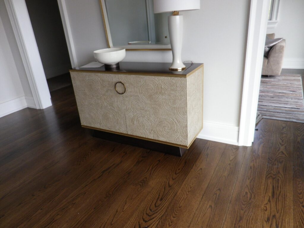 Refinished Baker Bill Sofield Le Panier credenza with ivory textured panels, photographed in the client’s home after delivery.