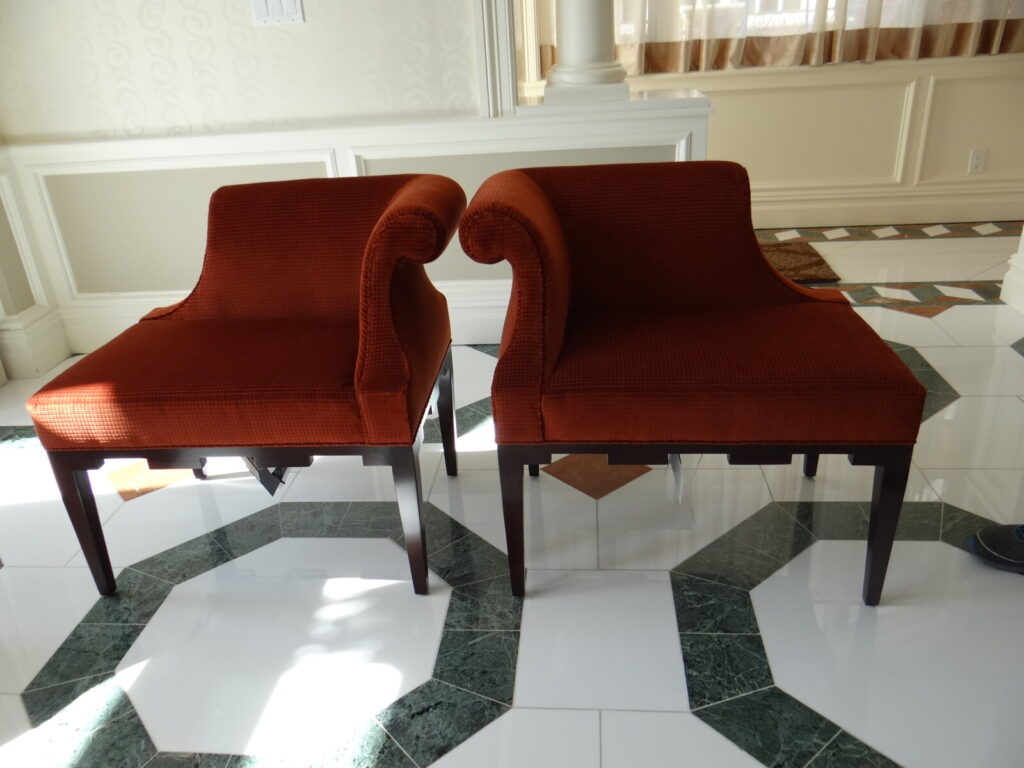 Pair of Baker castle corner chairs fully restored and upholstered by First Class MasterCraft.