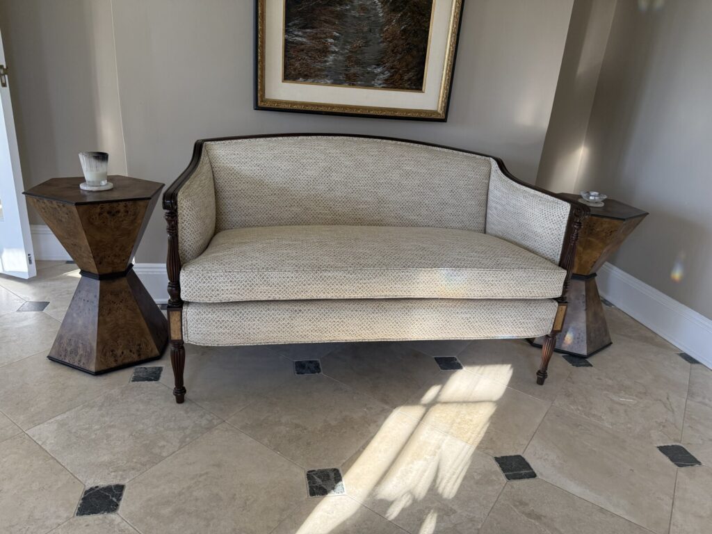 Antique settee restored and reupholstered, shown after completion in a finished interior.