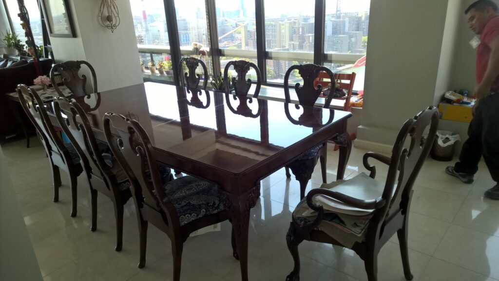 Refinished Baker Stately Homes mahogany dining table and reupholstered chairs photographed in the client’s home after delivery.