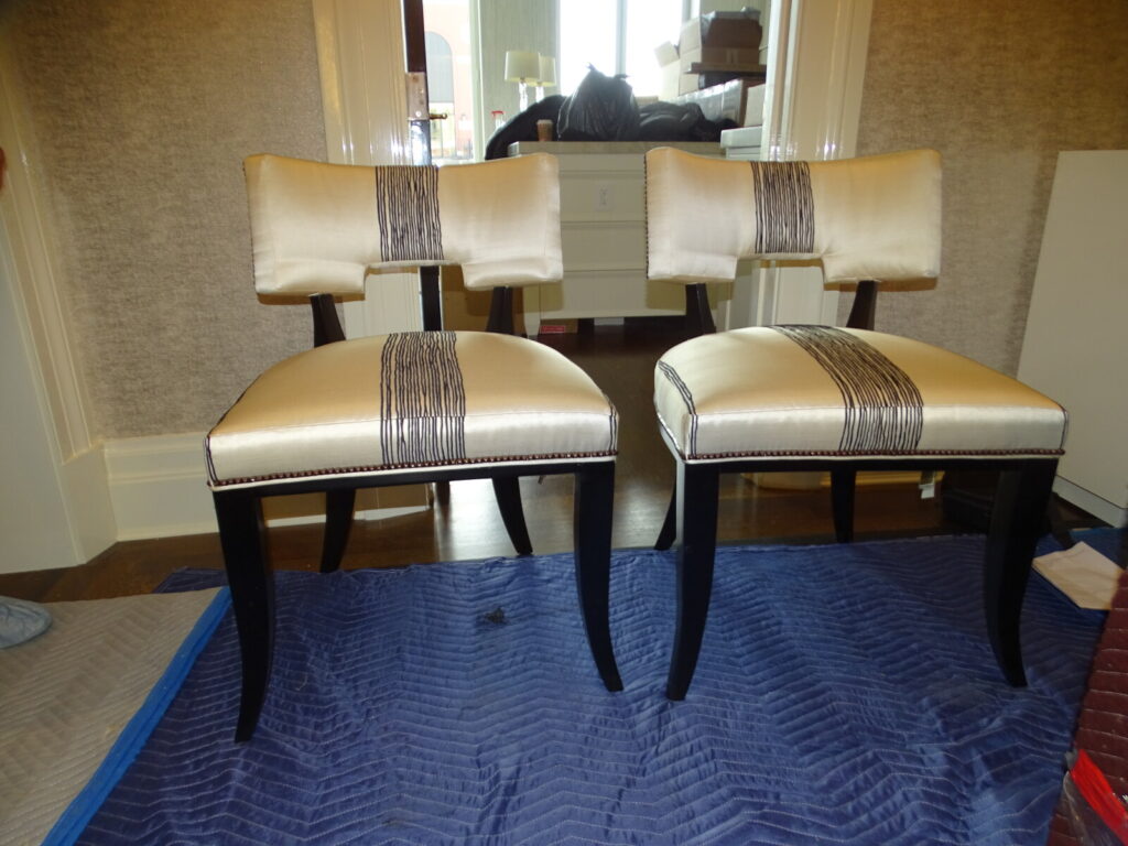 Pair of lounge chairs restored and shown after delivery in a finished interior.