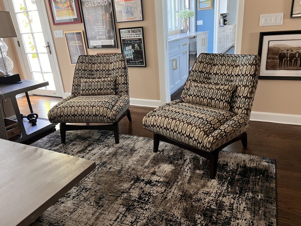 Single upholstered chair reupholstered and shown after delivery in a finished interior.