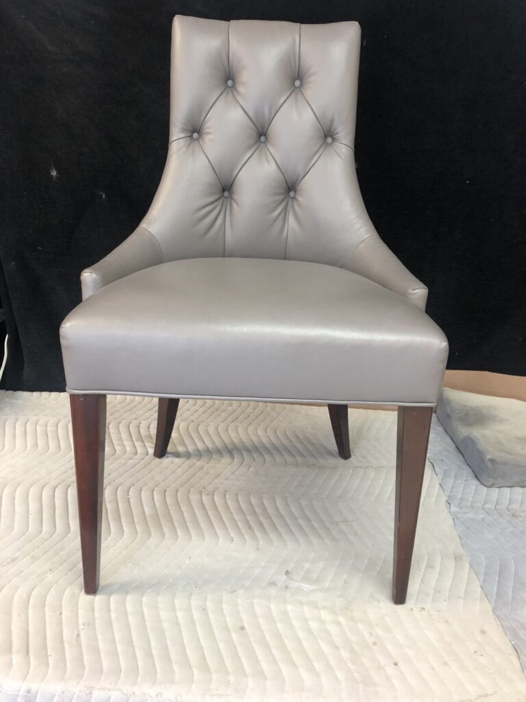 Single lounge chair fully reupholstered and photographed in the workshop after completion.