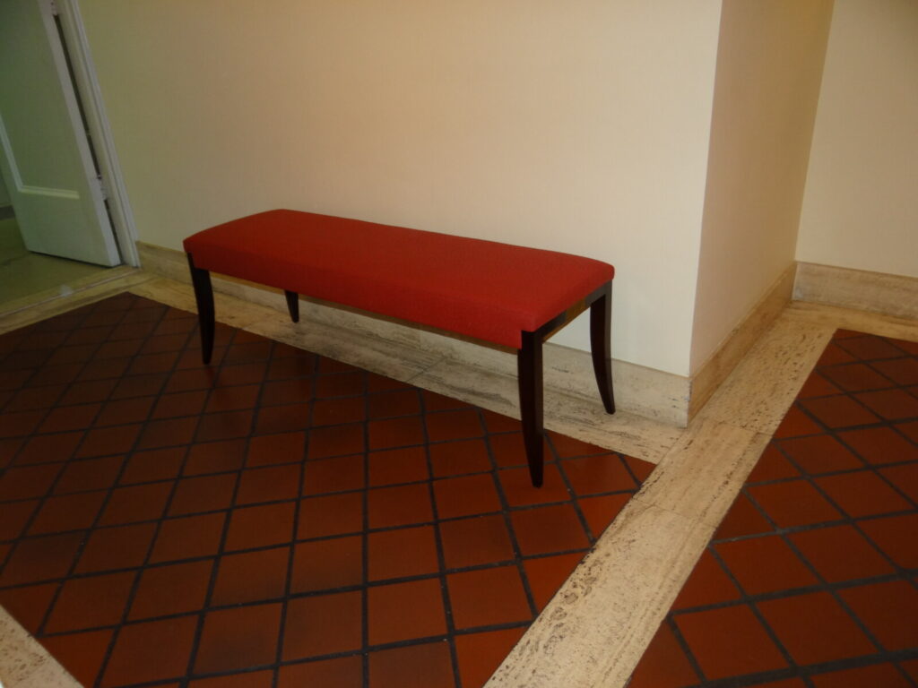 Baker Thomas Pheasant Atelier bench reupholstered in the correct fabric, photographed in the lobby after delivery.