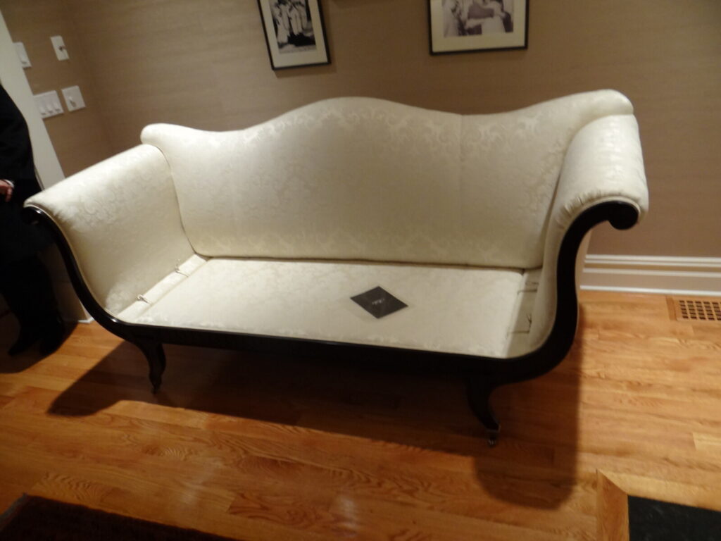 Upholstered sofa restored with structural repair and reupholstery, shown after delivery in a finished interior.