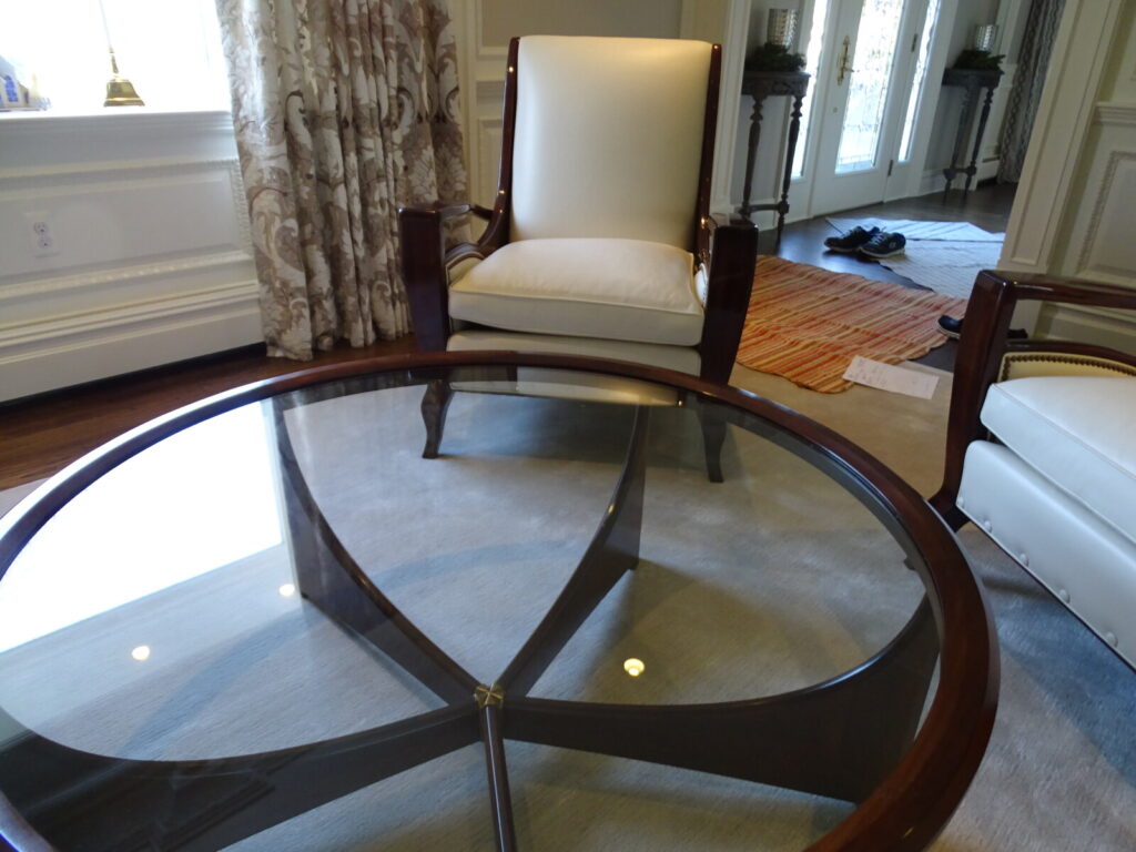 Single lounge chair refinished and reupholstered, shown after delivery in a completed interior.