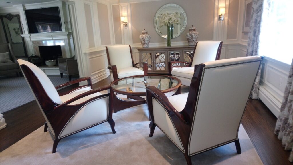 Refinished and reupholstered Hancock & Moore lounge chairs arranged in the client’s home, photographed in a bright, finished room.