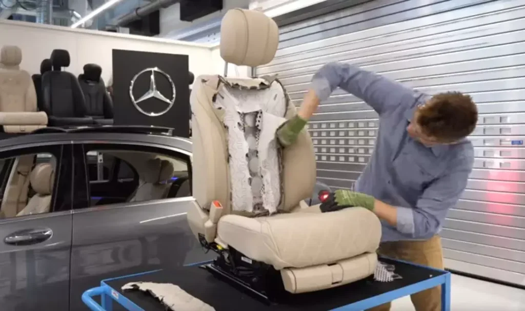Technician restoring a classic car interior as part of specialty automotive upholstery work.