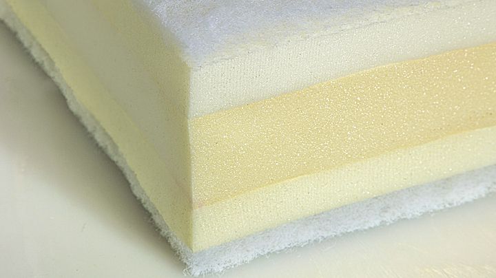 Close‑up of layered foam showing different densities used in premium cushion replacement.