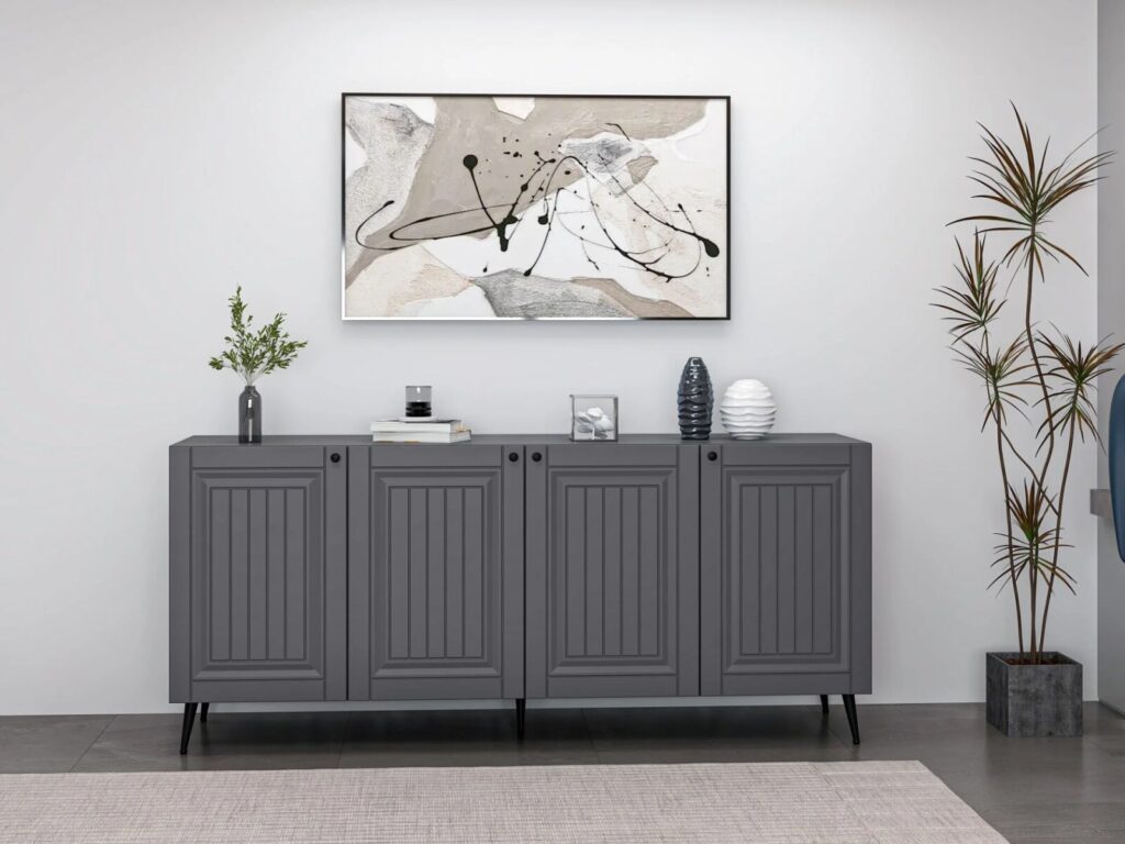 Dark gray sideboard with decorative items beneath a large abstract painting, next to a tall potted plant.