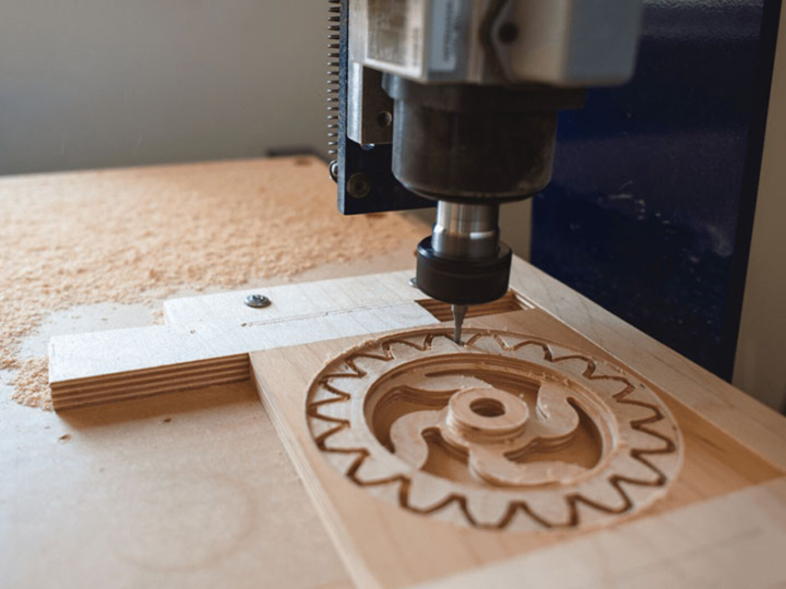 CNC machine cutting a wood panel with precision during the digital fabrication process.