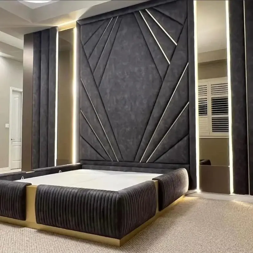 A modern geometric headboard with cnc‑cut angular patterns and integrated vertical lighting behind a dark upholstered bed with gold accents in a contemporary bedroom.