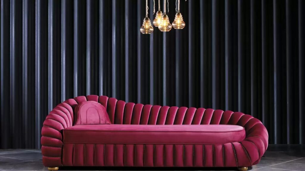 Custom‑built upholstered sofa in red fabric, photographed as a single standalone piece.