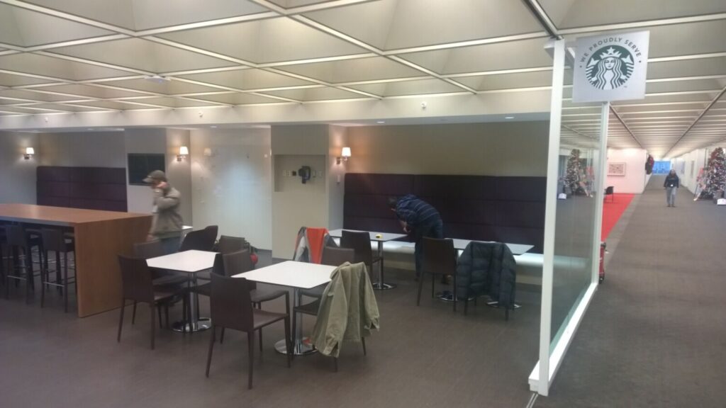 Finished commercial banquette with smooth upholstery and wood base in a retail space.