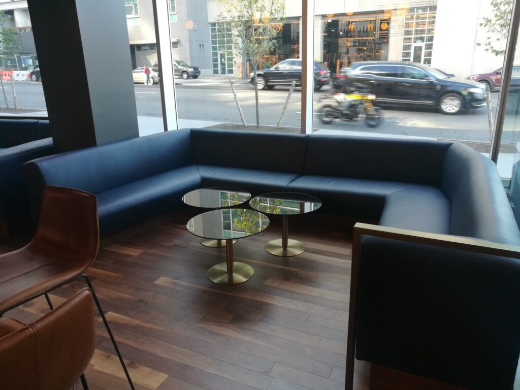 U-shaped banquette frame aligned against walls during installation.