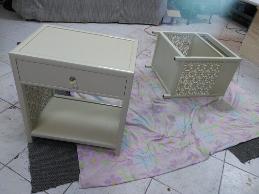 Pair of Baker nightstands on the shop floor during the refinishing process.
