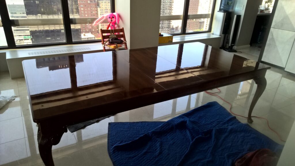 Baker Stately Homes mahogany dining table showing its restored high‑gloss finish in the client’s home.