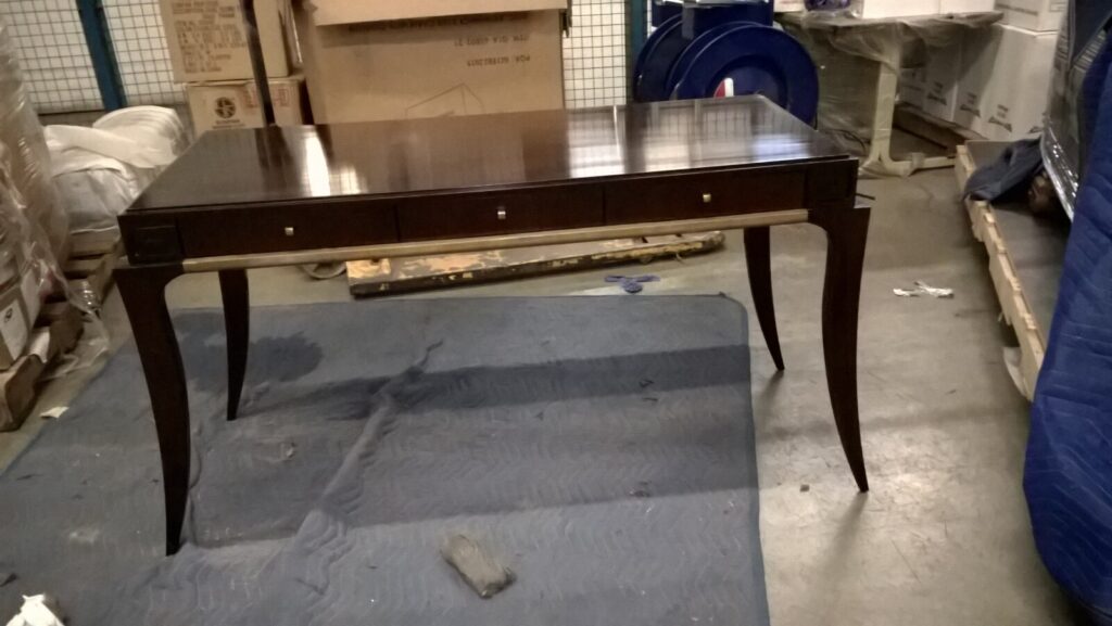 dressing table in the workshop before restoration, showing the original worn finish.