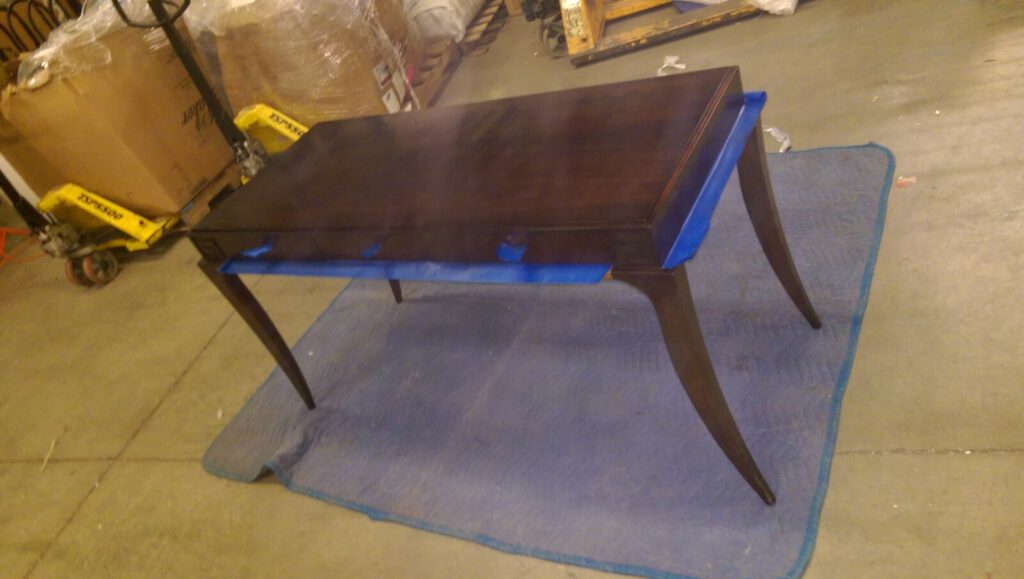 dressing table on the shop floor showing finish wear before restoration.