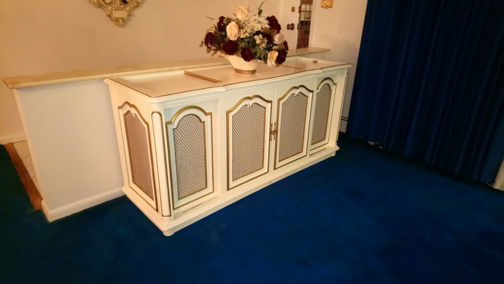 Antique cabinet fully restored and photographed in the client’s home after refinishing.