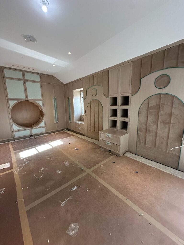 Close-up of the completed arched fabric wall panels showing the precise fit within the custom architectural millwork.