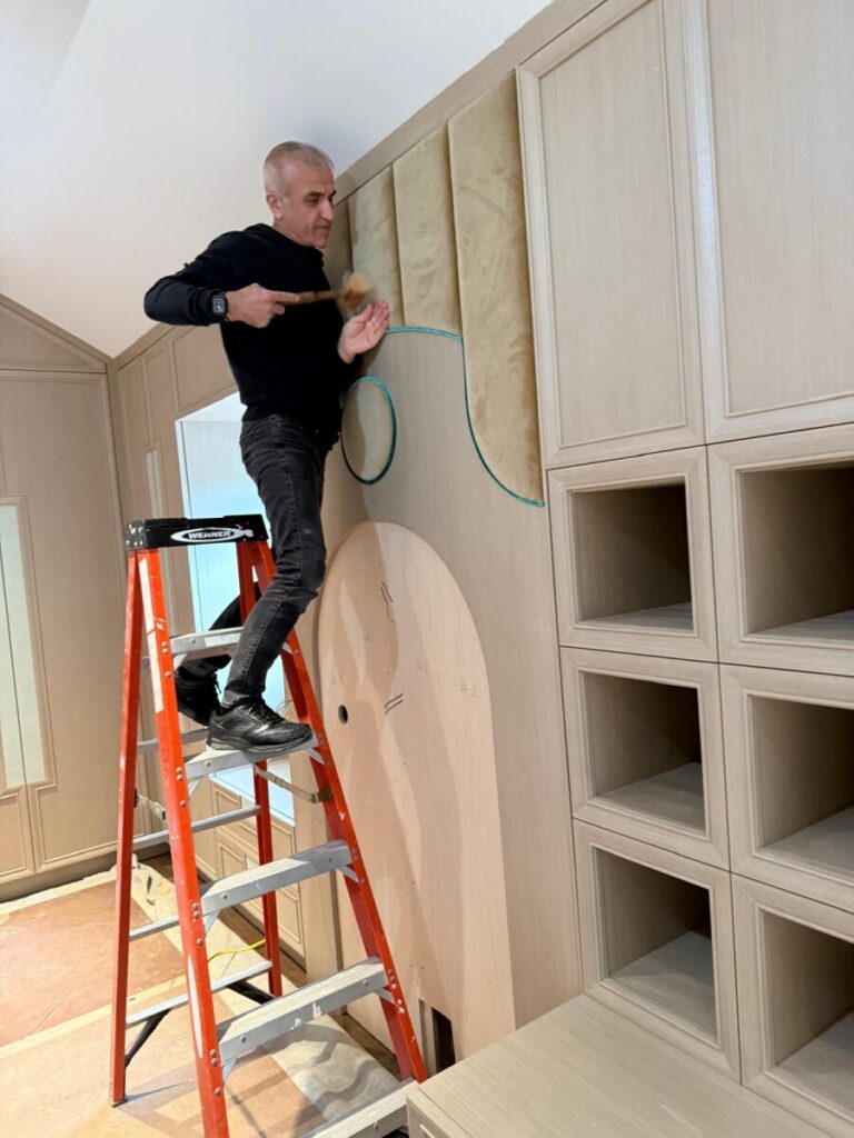 Curved wall panel installation on ladder