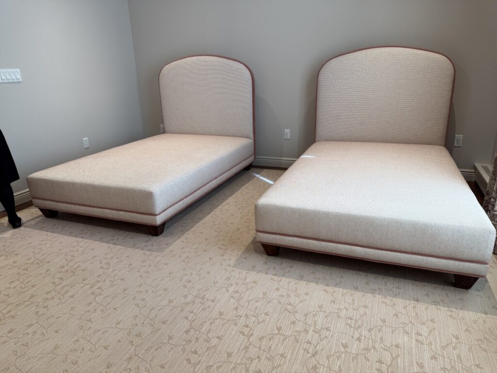 Completed bedroom installation featuring two arched twin headboards and matching custom bed frames.