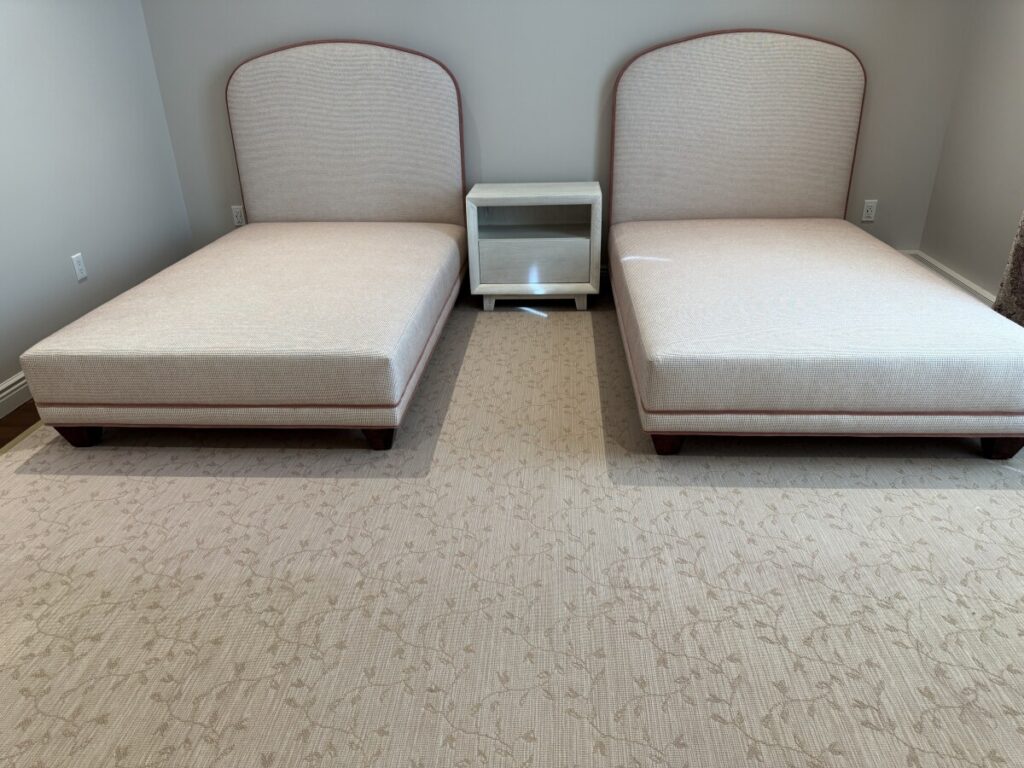 twin two beds and two headboard installed in modern bedroom with middle night stand.