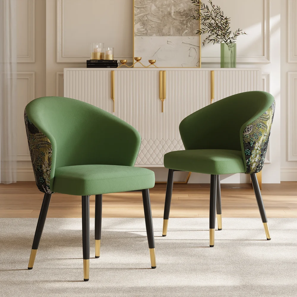 Pair of green upholstered accent chairs with patterned backs in a modern interior.