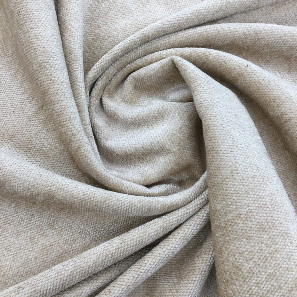 Closeup of light gray fabric twisted into a spiral showing its texture.